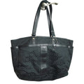 Black textured handbag on a white surface