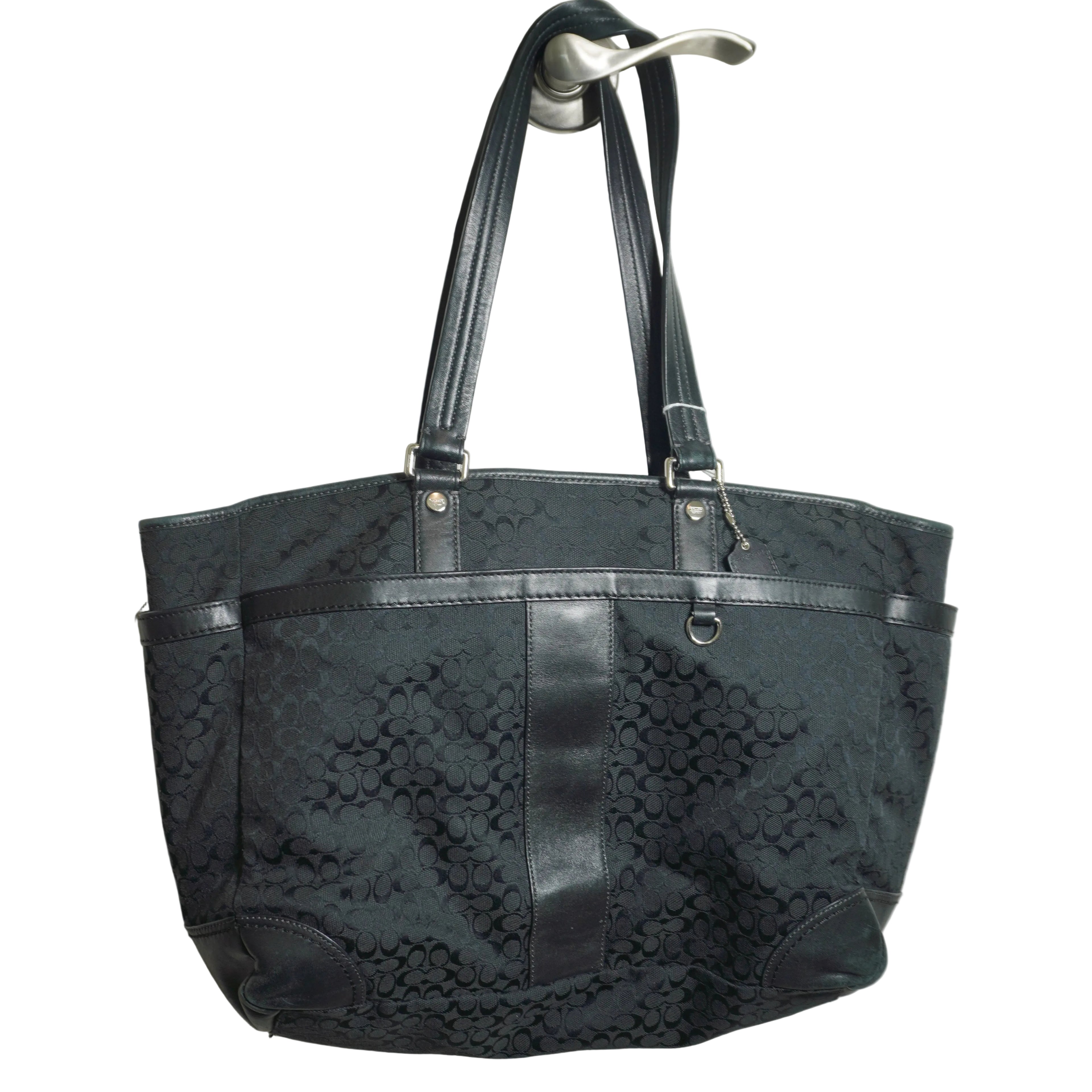 Black textured handbag on a white surface